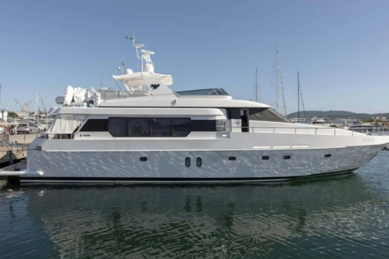  Yacht Photos Pics Luxury Codecasa 24 yacht from 1995 docked in a marina under clear blue skies.