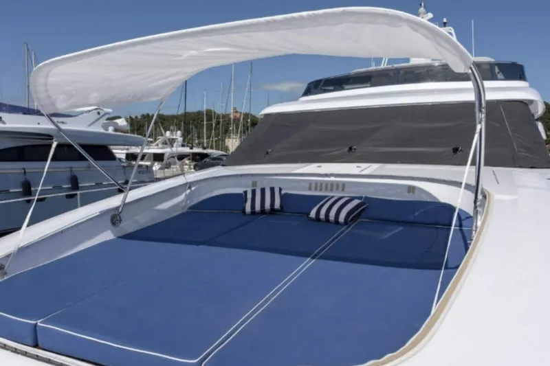  Yacht Photos Pics Luxurious 1995 Codecasa 24 yacht with sunshade and blue cushioned deck.