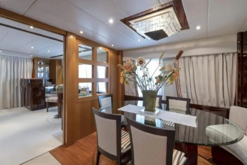  Yacht Photos Pics Luxurious dining area on a 1995 Codecasa 24 yacht, featuring elegant decor and floral centerpiece.