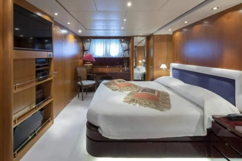  Yacht Photos Pics Luxurious bedroom interior on 1995 Codecasa 24 yacht, featuring elegant wood paneling and modern amenities.