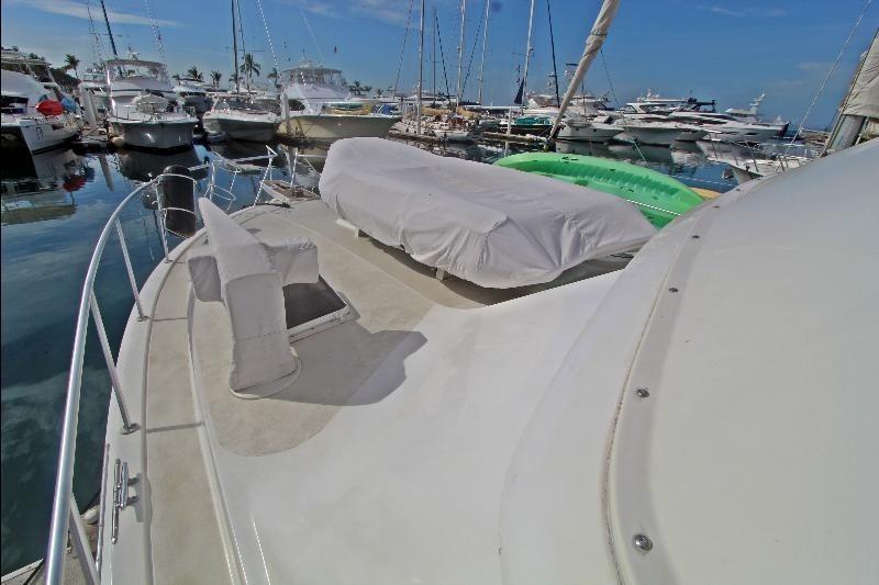 1994 Bertram 50 Convertible yacht docked in a marina, surrounded by other boats.