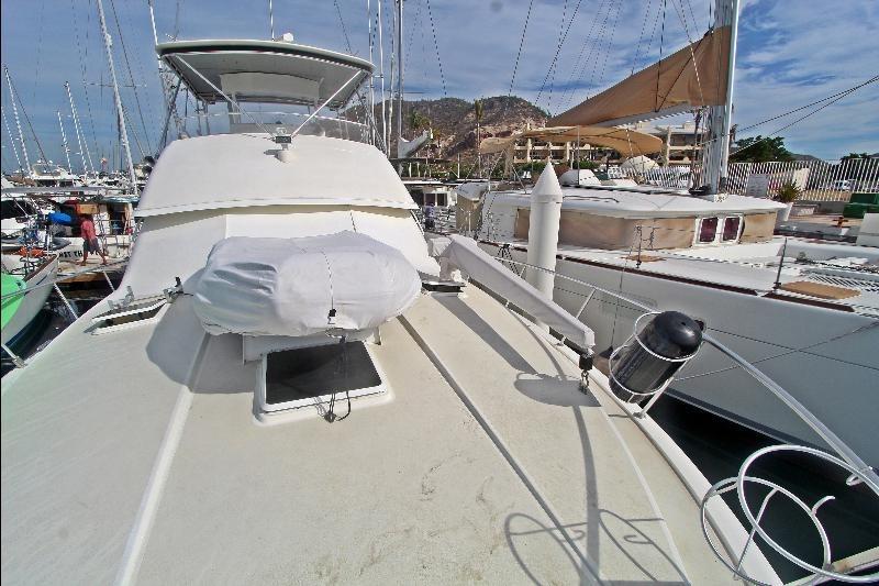 1994 Bertram 50 Convertible yacht docked in a marina, showcasing its spacious deck.