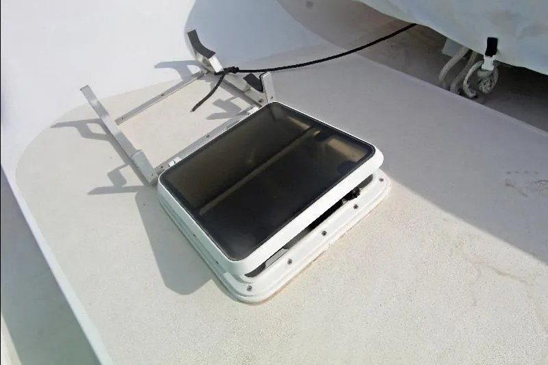  Yacht Photos Pics Hatch on 1994 Bertram 50 Convertible boat deck, partially open with securing mechanism.