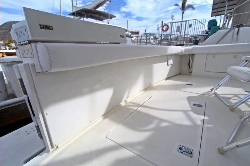 Yacht Photos Pics 1994 Bertram 50 Convertible yacht deck with seating and storage compartments.