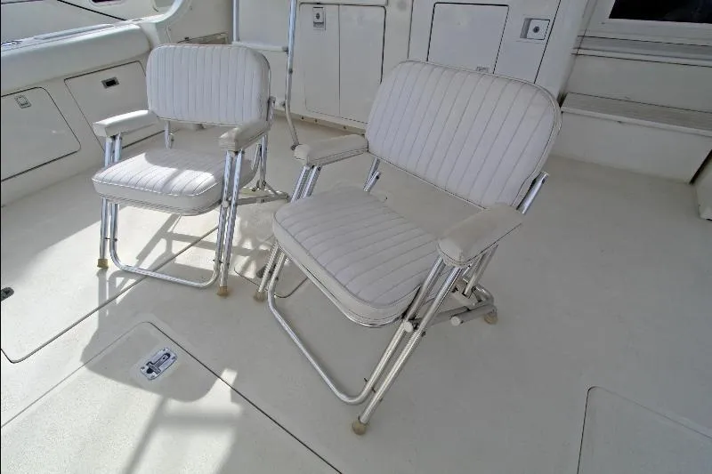  Yacht Photos Pics White cushioned chairs on 1994 Bertram 50 Convertible yacht deck.
