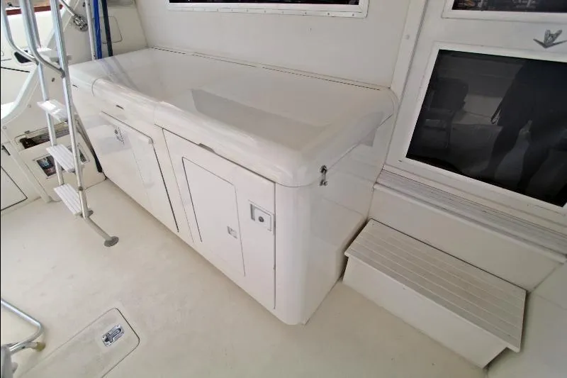  Yacht Photos Pics 1994 Bertram 50 Convertible yacht interior with white cabinetry and ladder.