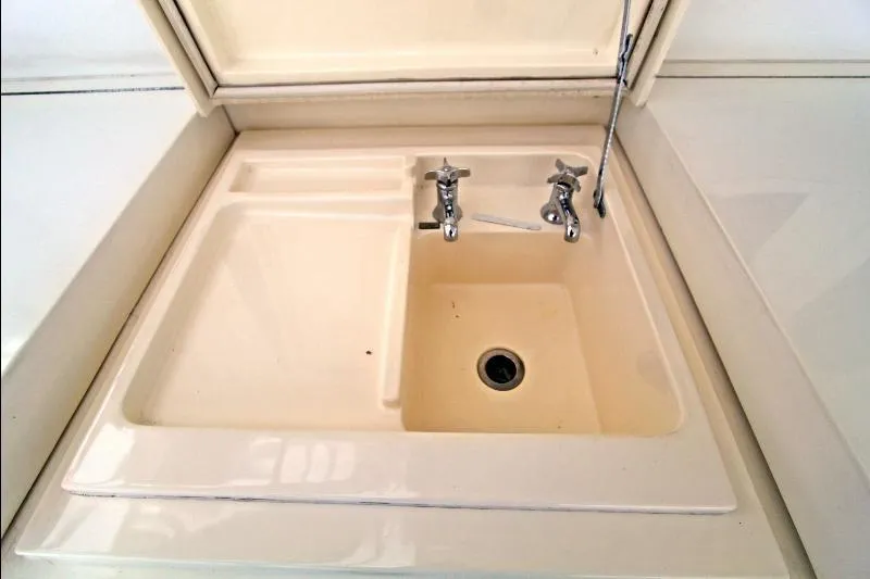  Yacht Photos Pics Cream-colored sink with dual faucets on a 1994 Bertram 50 Convertible yacht.