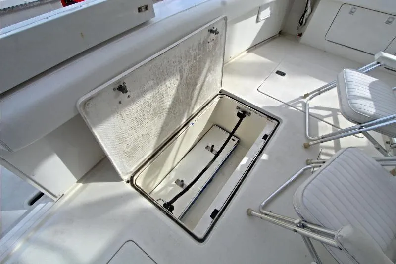  Yacht Photos Pics 1994 Bertram 50 Convertible boat deck with open storage compartment and seating.