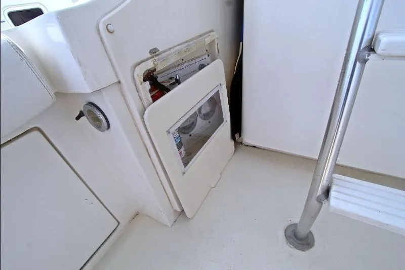  Yacht Photos Pics 1994 Bertram 50 Convertible boat interior with open storage compartment and visible fire extinguisher.