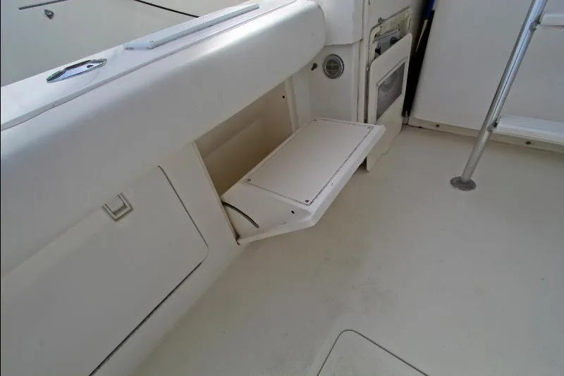  Yacht Photos Pics 1994 Bertram 50 Convertible yacht interior with foldable seat and storage compartment.