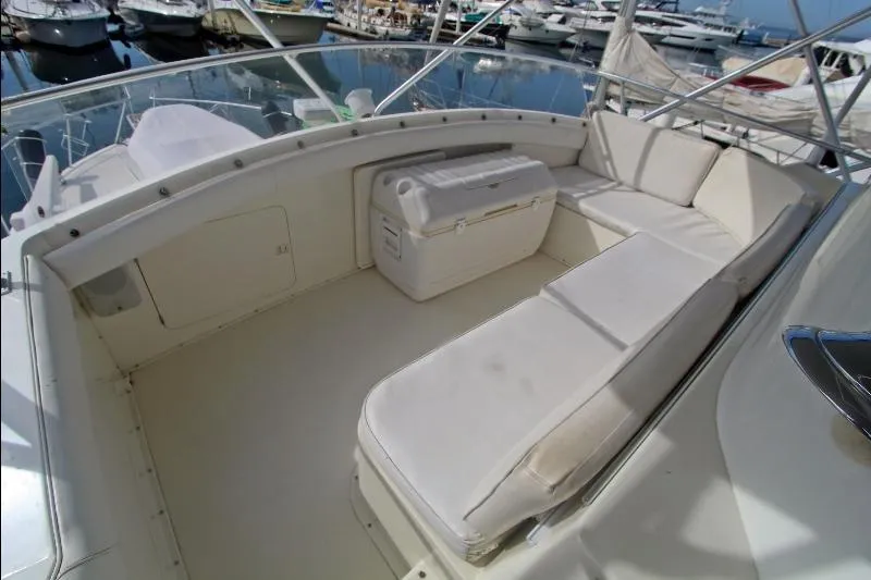  Yacht Photos Pics 1994 Bertram 50 Convertible yacht with spacious white seating area at marina.