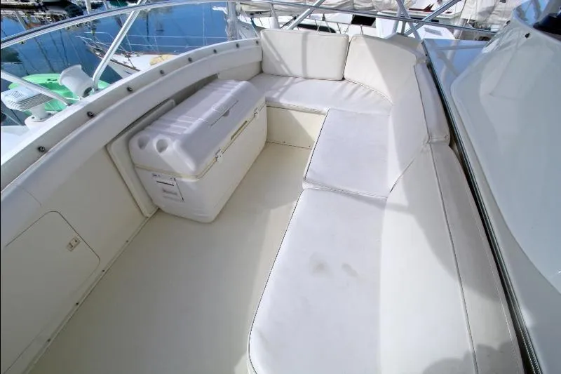  Yacht Photos Pics 1994 Bertram 50 Convertible yacht with white cushioned seating and cooler on deck.
