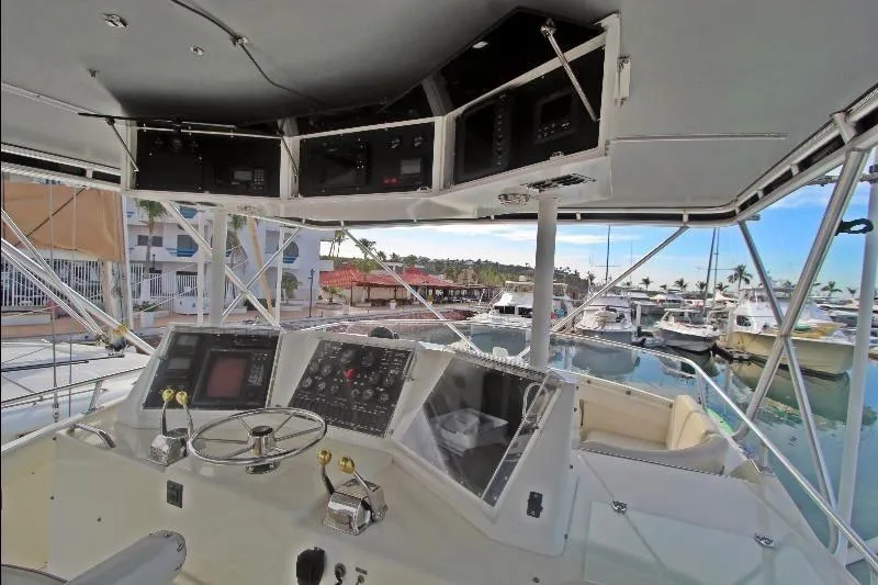  Yacht Photos Pics Cockpit view of a 1994 Bertram 50 Convertible yacht with marina background.