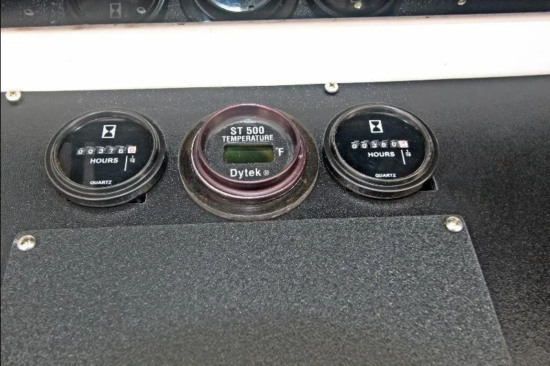  Yacht Photos Pics Instrument panel of a 1994 Bertram 50 Convertible with hour meters and temperature gauge.