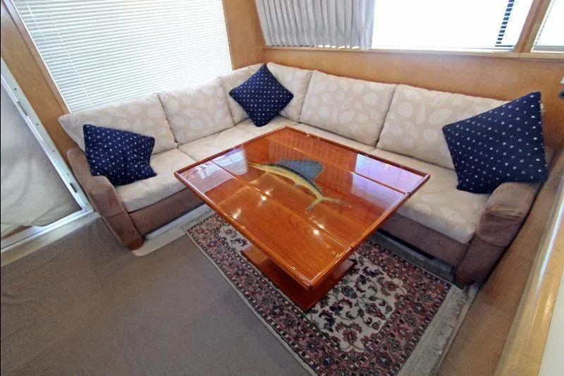  Yacht Photos Pics Cozy interior of 1994 Bertram 50 Convertible with elegant seating and wooden table.