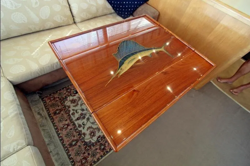  Yacht Photos Pics Luxurious wooden table with marlin inlay on 1994 Bertram 50 Convertible yacht.