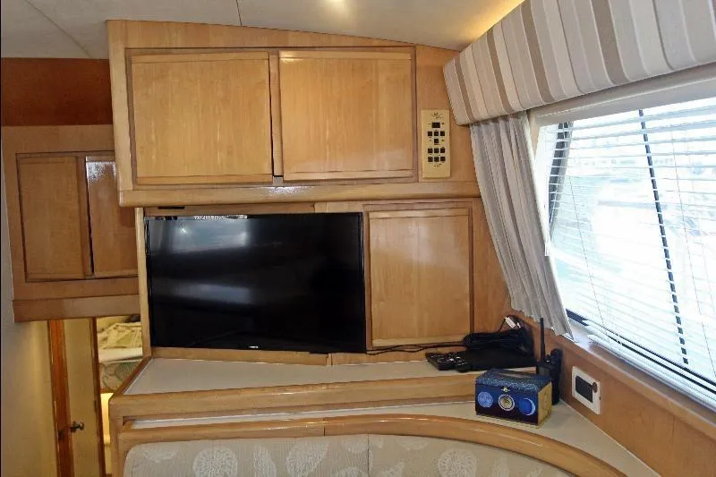  Yacht Photos Pics Interior of 1994 Bertram 50 Convertible yacht with TV and wooden cabinets.