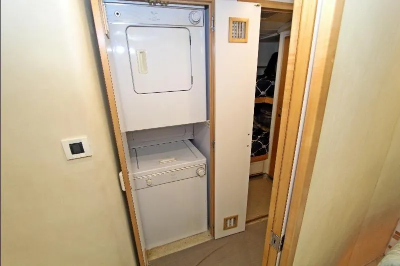  Yacht Photos Pics Stacked washer and dryer in 1994 Bertram 50 Convertible yacht interior.