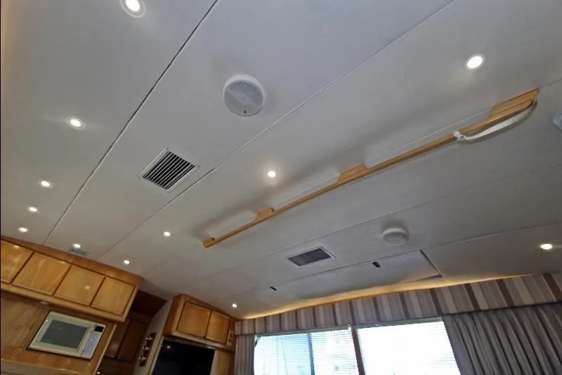  Yacht Photos Pics Interior ceiling of a 1994 Bertram 50 Convertible yacht with lighting and wood accents.