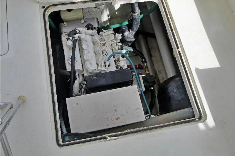  Yacht Photos Pics Engine compartment of a 1994 Bertram 50 Convertible boat, showcasing mechanical components.