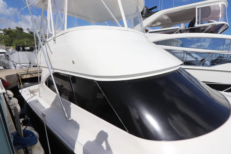 Juris Tantrum Yacht Photos Pics 2011 Viking 46 Convertible yacht docked at marina under clear blue sky.