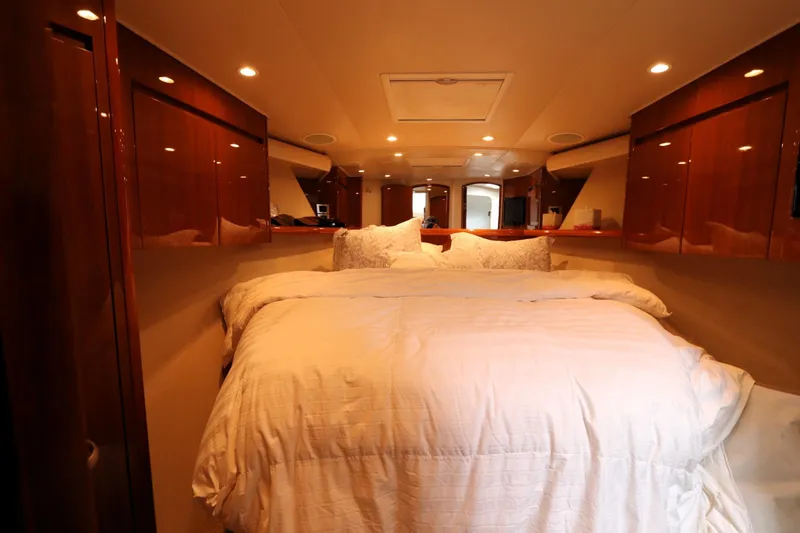 Juris Tantrum Yacht Photos Pics Luxurious bedroom interior of 2011 Viking 46 Convertible yacht with elegant wood finishes.