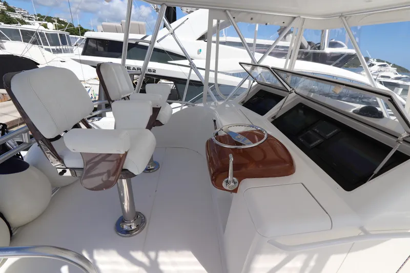 Juris Tantrum Yacht Photos Pics 2011 Viking 46 Convertible yacht helm with white seating and navigation controls.