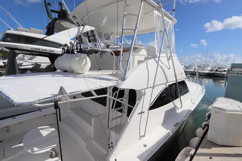 Juris Tantrum Yacht Photos Pics 2011 Viking 46 Convertible yacht docked at marina under clear blue sky.