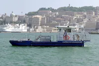 Custom C.P.N Pelikan boat in harbor, 2024 model, with cityscape background.