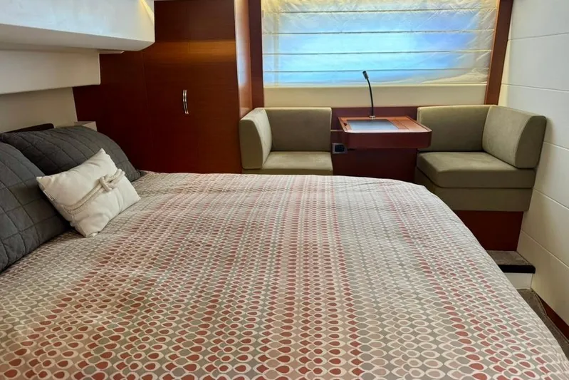 My Three Es Yacht Photos Pics Luxurious bedroom interior of 2016 Prestige 500 S yacht with modern decor and seating area.