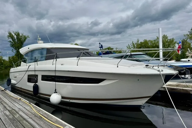 My Three Es Yacht Photos Pics 2016 Prestige 500 S yacht docked, cloudy sky, surrounded by trees and water.