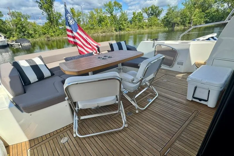 My Three Es Yacht Photos Pics Luxury 2016 Prestige 500 S yacht deck with seating, table, and American flag.