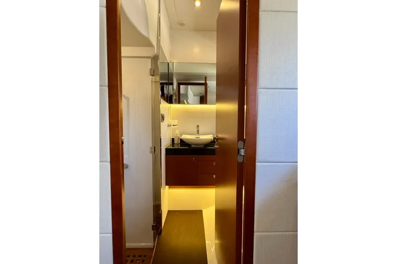 My Three Es Yacht Photos Pics Luxurious bathroom interior of 2016 Prestige 500 S yacht, featuring modern sink and warm lighting.