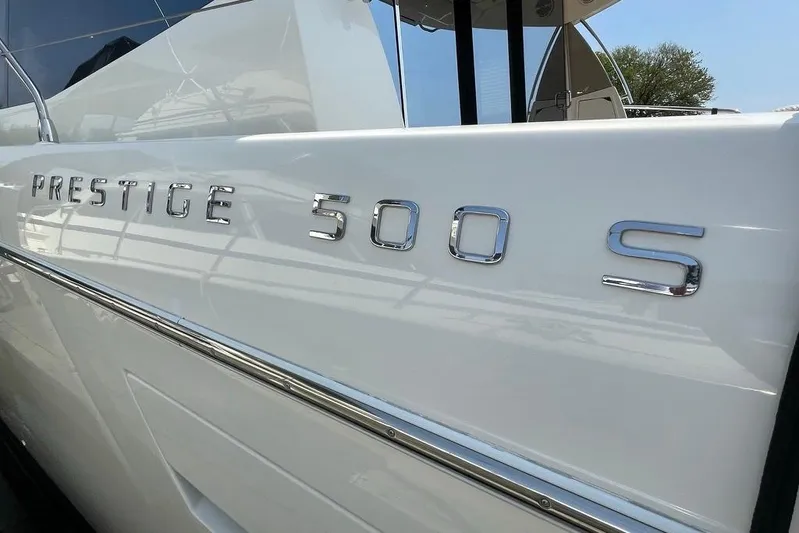 My Three Es Yacht Photos Pics 2016 Prestige 500 S yacht, sleek white exterior with chrome lettering.