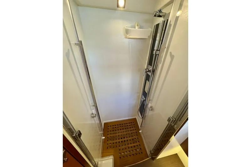 My Three Es Yacht Photos Pics Shower area in 2016 Prestige 500 S yacht with wooden floor and modern fixtures.
