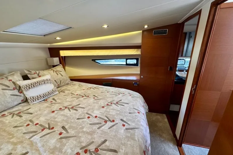 My Three Es Yacht Photos Pics Luxurious bedroom interior of 2016 Prestige 500 S yacht with elegant bedding and wood accents.