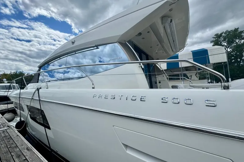 My Three Es Yacht Photos Pics 2016 Prestige 500 S yacht docked, showcasing sleek design and modern features under a cloudy sky.