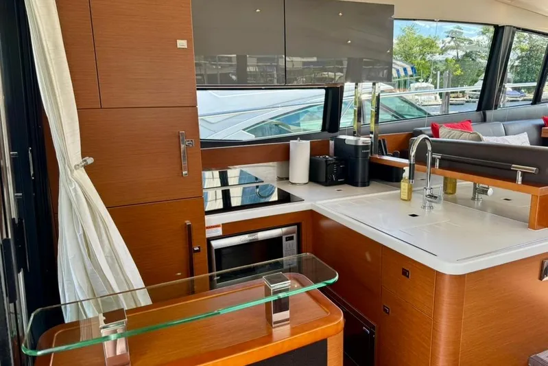 My Three Es Yacht Photos Pics Luxurious 2016 Prestige 500 S yacht kitchen with modern appliances and sleek wood cabinetry.