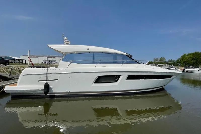 My Three Es Yacht Photos Pics 2016 Prestige 500 S yacht docked on calm water under clear blue sky.