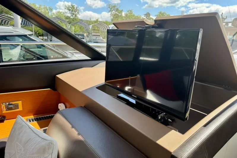 My Three Es Yacht Photos Pics Interior of 2016 Prestige 500 S yacht with retractable TV and luxurious seating.