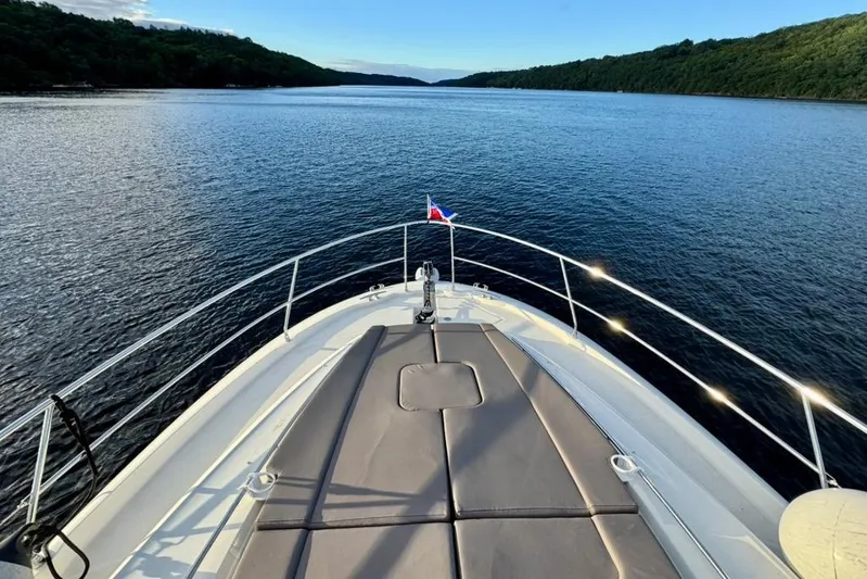 My Three Es Yacht Photos Pics Bow view of 2016 Prestige 500 S yacht on serene waterway.