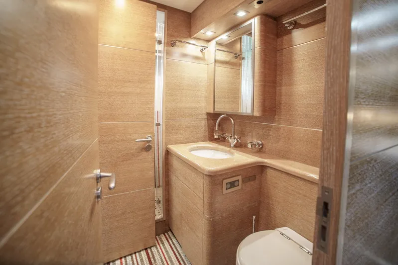 Ganache Yacht Photos Pics Luxurious bathroom in 2005 Leopard 24 yacht with modern fixtures and warm lighting.