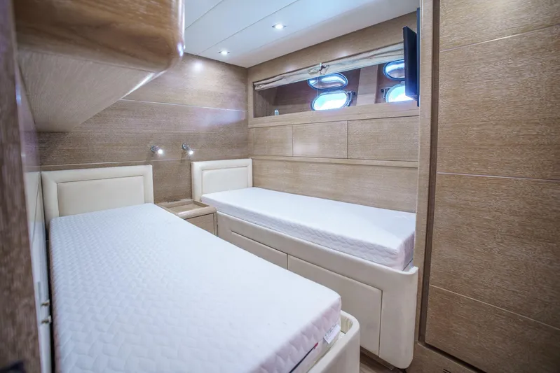 Ganache Yacht Photos Pics Twin cabin interior of 2005 Leopard 24 yacht with modern wood finish.