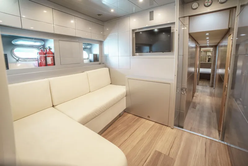 Ganache Yacht Photos Pics Luxurious yacht interior with cream sofa, modern cabinetry, and flat-screen TV, Leopard 24, 2005 model.
