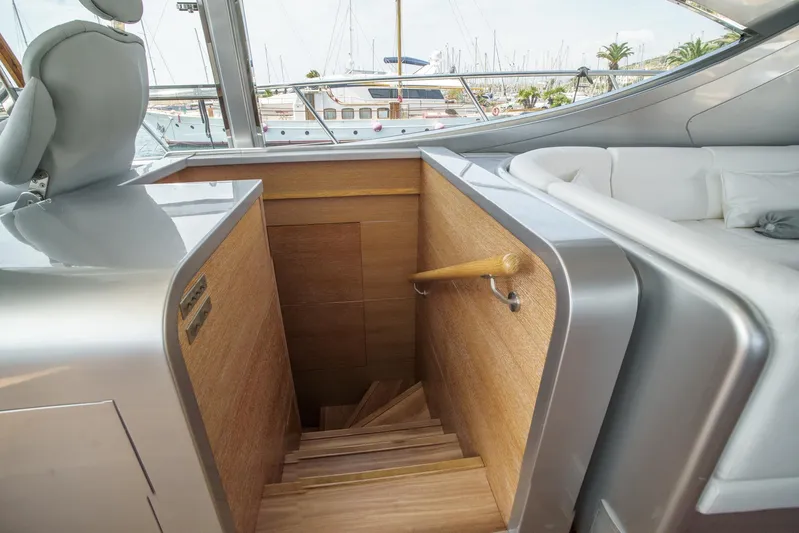 Ganache Yacht Photos Pics Staircase on a 2005 Leopard 24 yacht, featuring sleek wood and metal design.