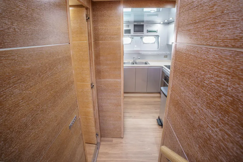 Ganache Yacht Photos Pics Modern yacht kitchen interior with wood paneling, stainless steel appliances, and ample natural light. Leopard 24, 2005.