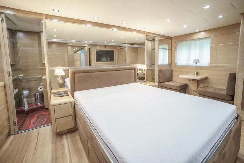 Ganache Yacht Photos Pics Luxurious bedroom interior in a 2005 Leopard 24 yacht, featuring modern design and elegant furnishings.