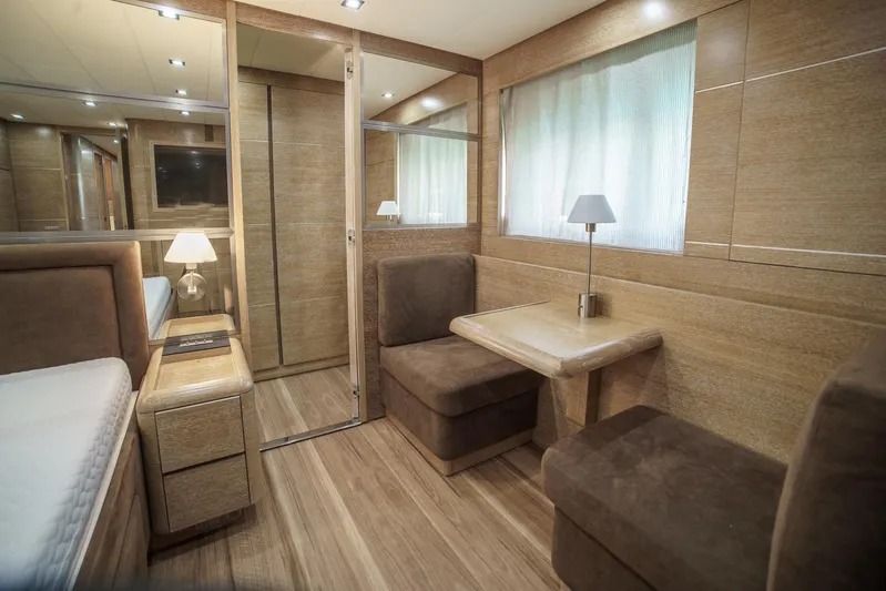 Ganache Yacht Photos Pics Luxurious interior of a 2005 Leopard 24 yacht with wood paneling and cozy seating.