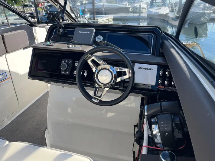  Yacht Photos Pics 2017 Sea Ray SLX 310 boat cockpit with steering wheel and control panel.
