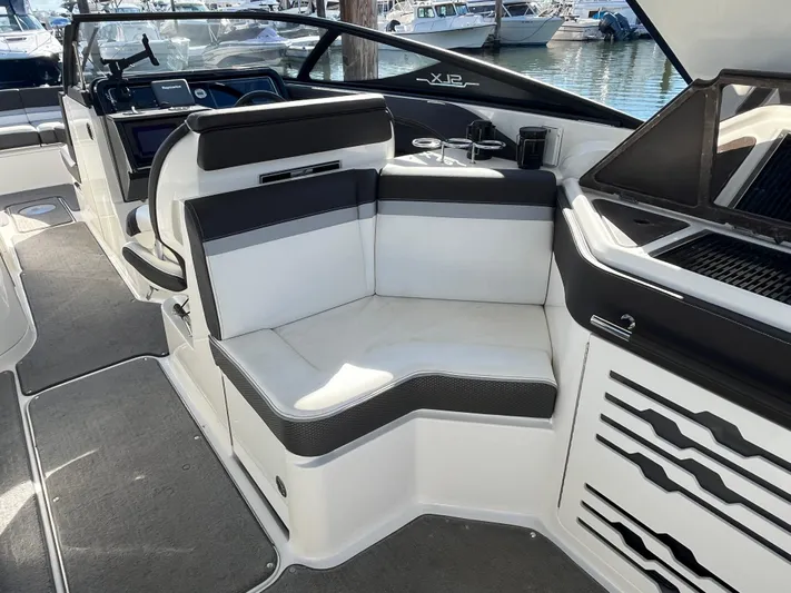  Yacht Photos Pics 2017 Sea Ray SLX 310 boat interior with seating and helm, docked at marina.
